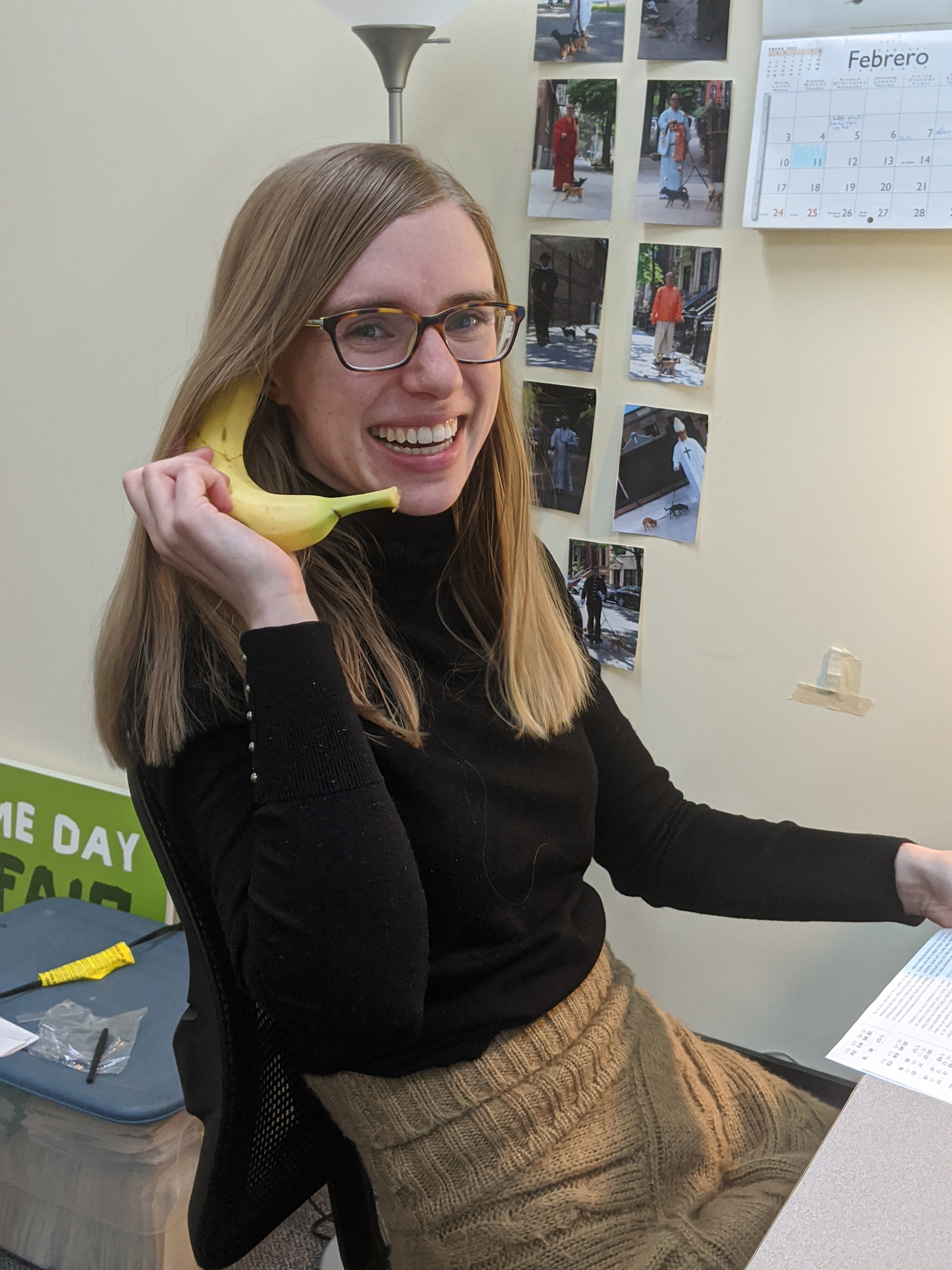 Emily at Equal Exchange holding a banana like a phone