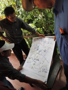 Members of COMSA looking at a flip chart with notes from workshop.