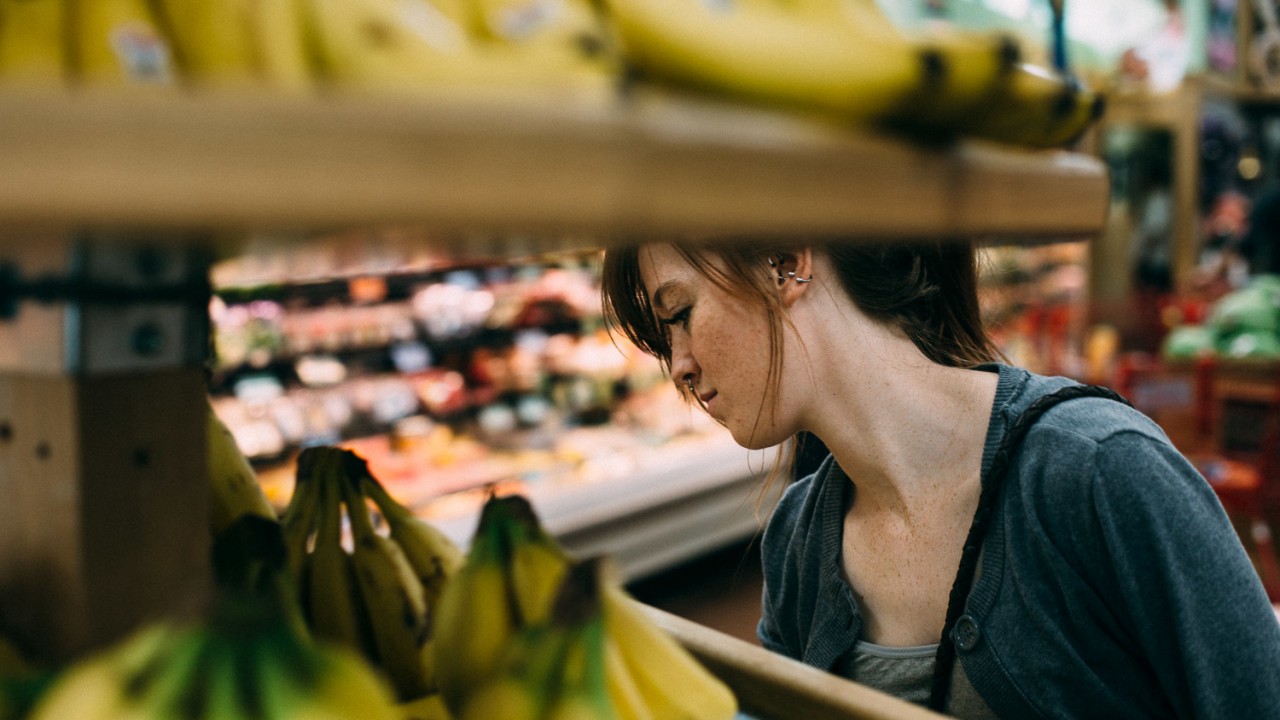 a shopper buys bananas 