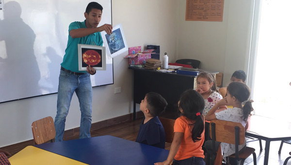 Teacher with students at a school built with fair trade premiums from COMSA.